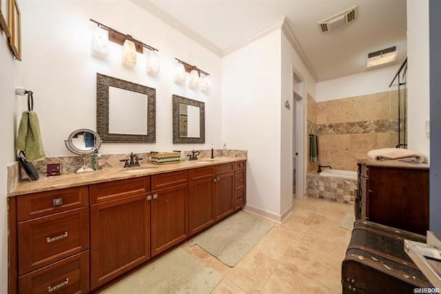 bathroom with tile patterned flooring, vanity, tiled bath, and ornamental molding