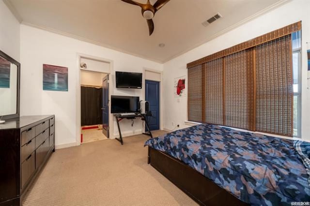 bedroom with ceiling fan, crown molding, and light colored carpet