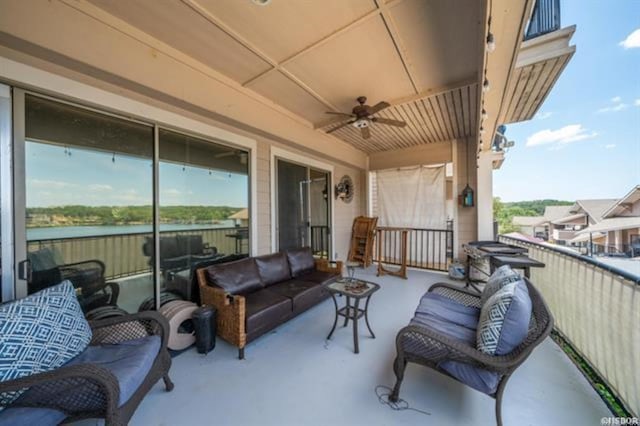 balcony featuring ceiling fan and a water view