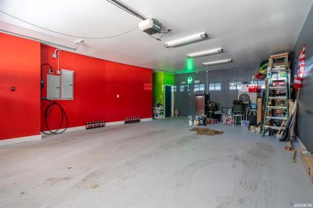 garage with electric panel and a garage door opener