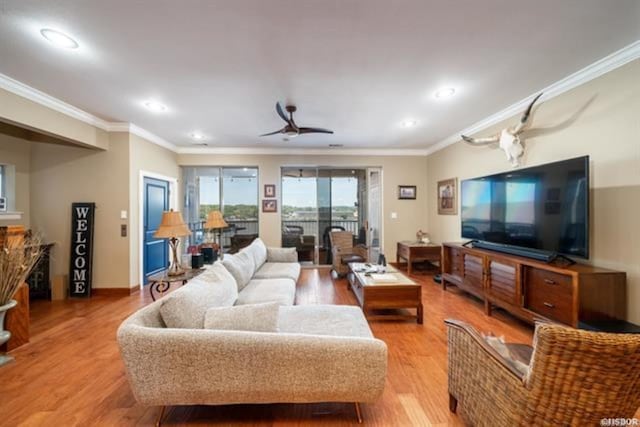 living room featuring crown molding, ceiling fan, and light hardwood / wood-style floors