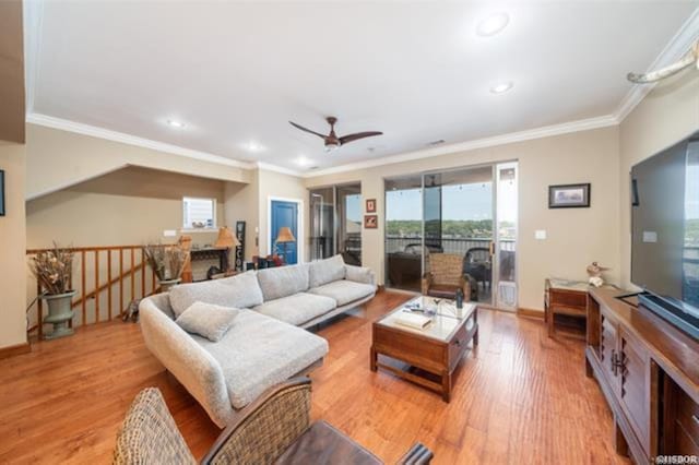 living room with light hardwood / wood-style flooring, ceiling fan, and crown molding