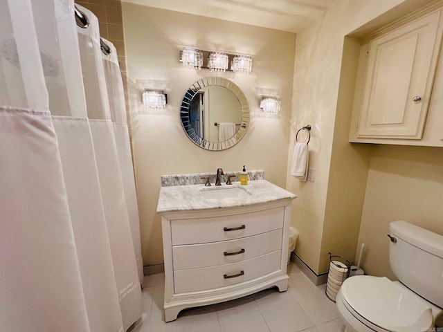 bathroom featuring toilet, vanity, and tile patterned floors