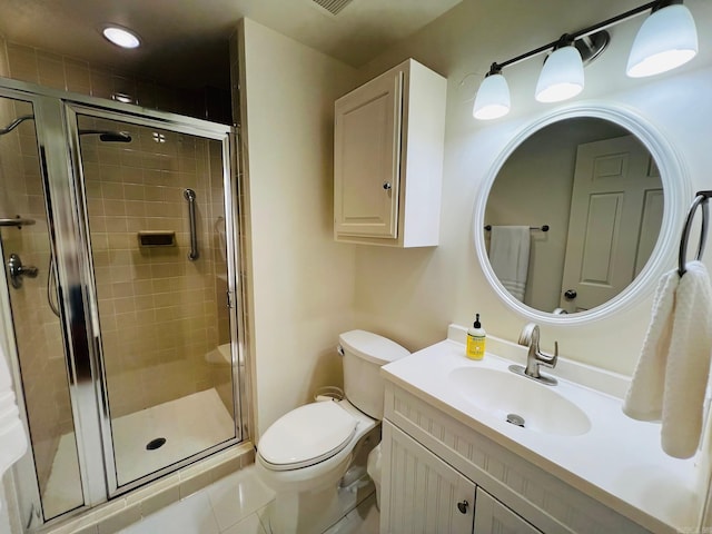 bathroom with tile patterned flooring, a shower with door, vanity, and toilet