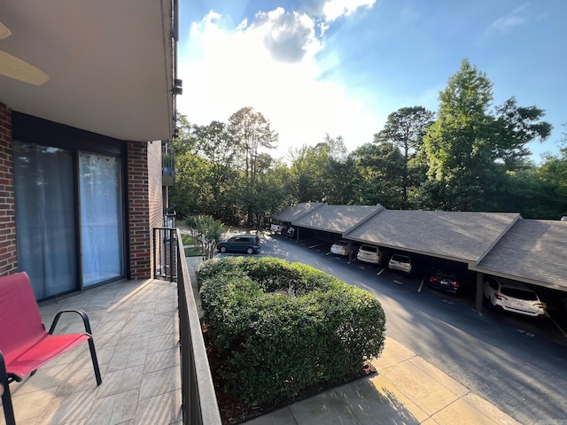 exterior space featuring a balcony and ceiling fan