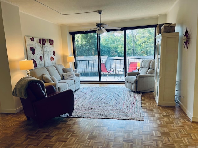 living room with ceiling fan, plenty of natural light, and parquet flooring