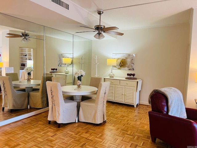 dining area featuring built in shelves and light parquet floors