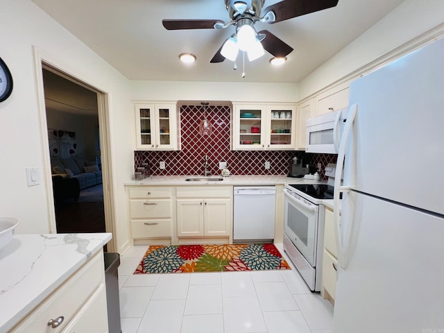 kitchen featuring ceiling fan, sink, backsplash, white appliances, and light tile patterned floors