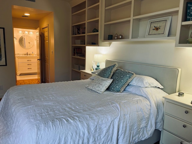 bedroom featuring sink and connected bathroom