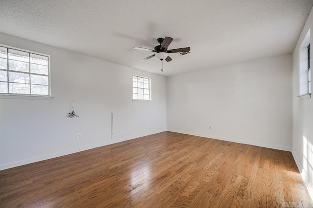 unfurnished room with a textured ceiling, light hardwood / wood-style flooring, and ceiling fan