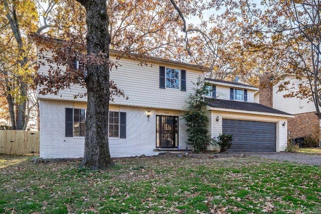 view of property featuring a front yard and a garage