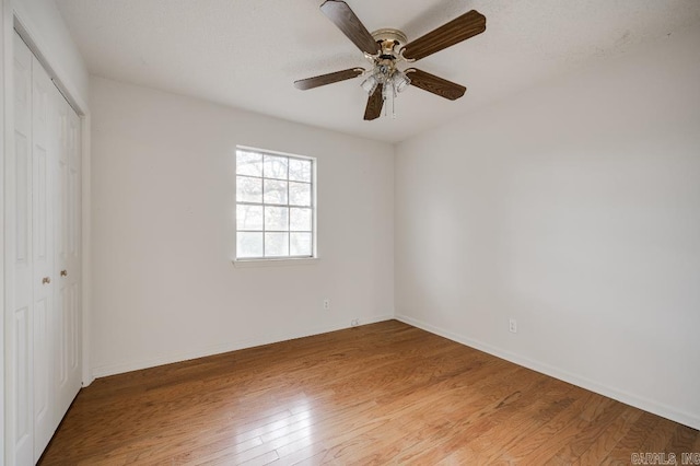 unfurnished bedroom featuring a closet, ceiling fan, and light hardwood / wood-style flooring