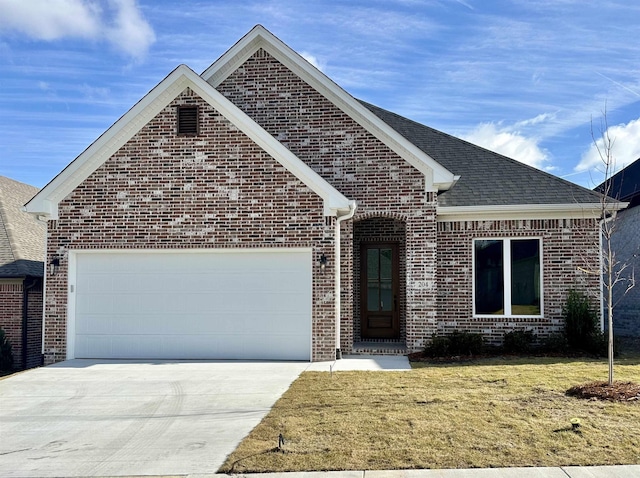 view of front of property with a front yard and a garage