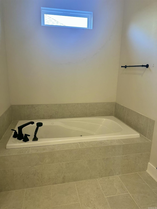 bathroom featuring tiled tub