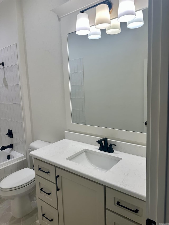 full bathroom featuring tile patterned floors, vanity, toilet, and tiled shower / bath combo