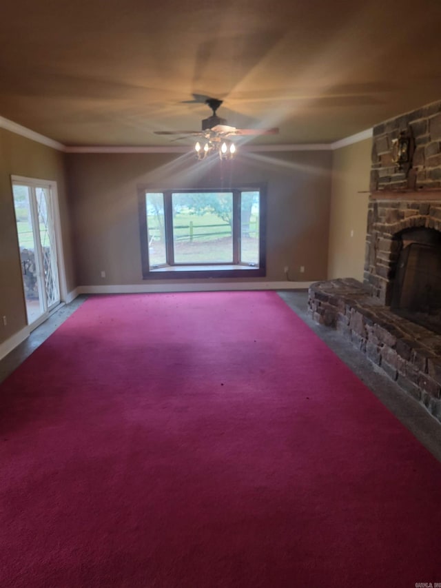 unfurnished living room featuring ceiling fan, a fireplace, crown molding, and carpet flooring