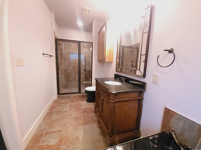 bathroom with toilet, vanity, and walk in shower