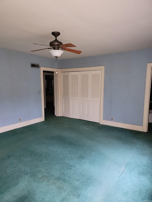 unfurnished bedroom featuring ceiling fan, a closet, and carpet floors