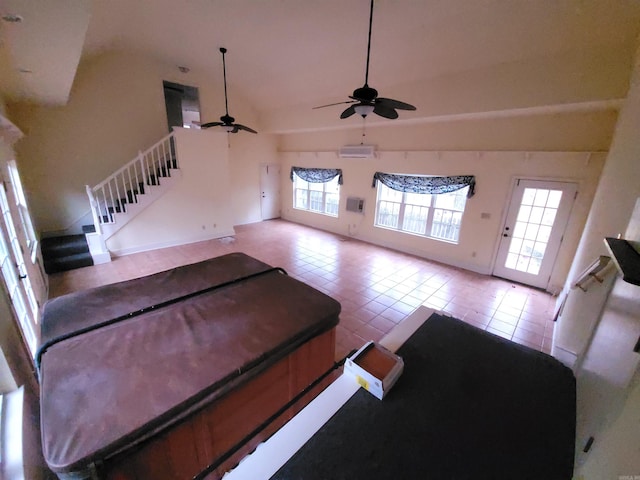 unfurnished living room featuring ceiling fan, light tile patterned floors, and vaulted ceiling