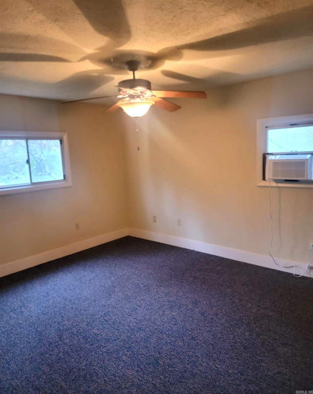 spare room with ceiling fan, a healthy amount of sunlight, and cooling unit