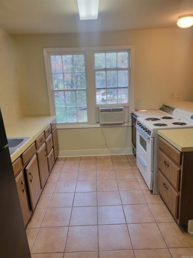 kitchen featuring a wealth of natural light, light tile patterned floors, and white electric range