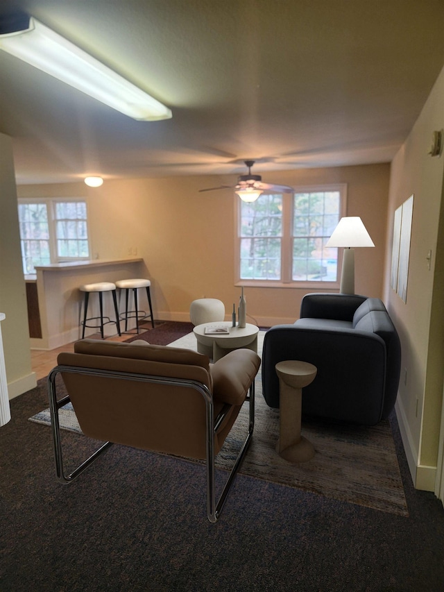 carpeted living room featuring ceiling fan