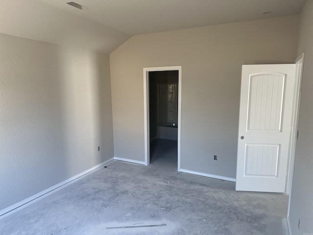 spare room with vaulted ceiling