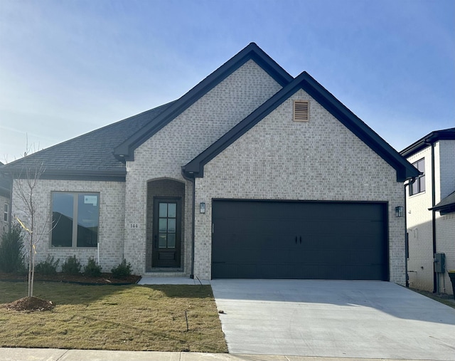 view of front of home with a garage and a front yard