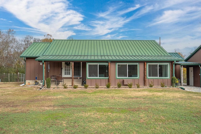 view of front of property with covered porch and a front lawn