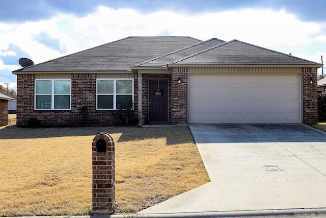 view of front of property with a front yard and a garage