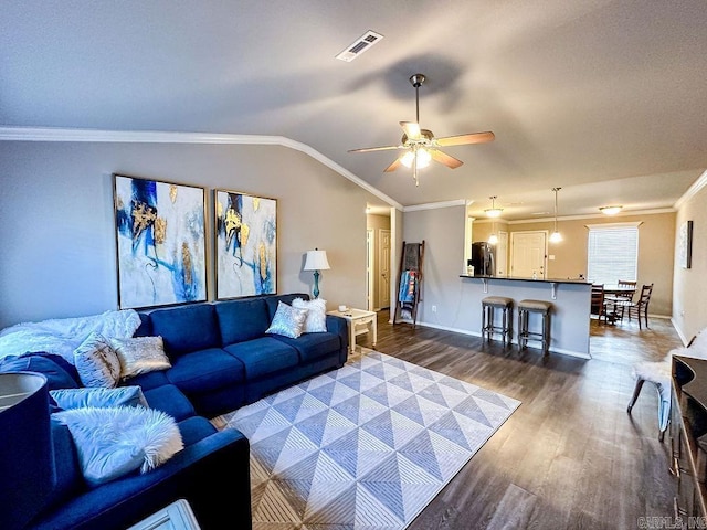 living room featuring ceiling fan, dark hardwood / wood-style flooring, crown molding, and vaulted ceiling