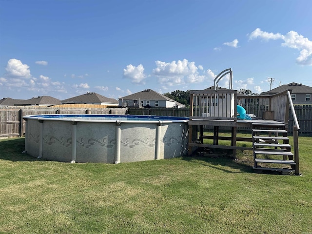 view of pool with a yard