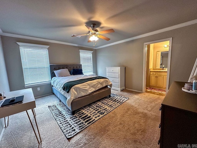 carpeted bedroom featuring ceiling fan, ensuite bath, ornamental molding, and multiple windows