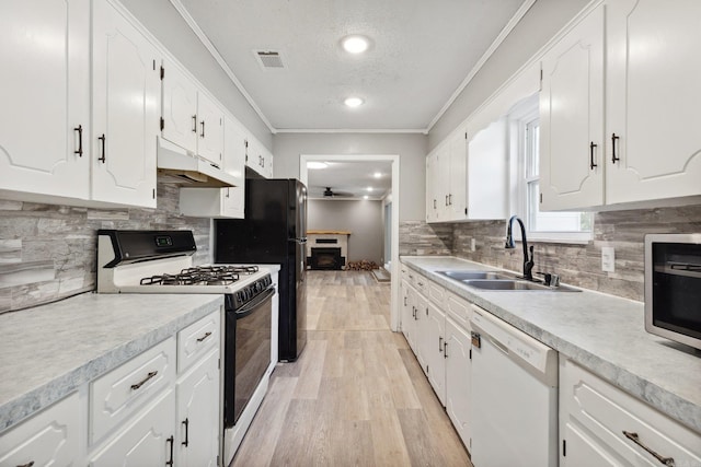 kitchen with white cabinetry, light wood-type flooring, white appliances, and sink