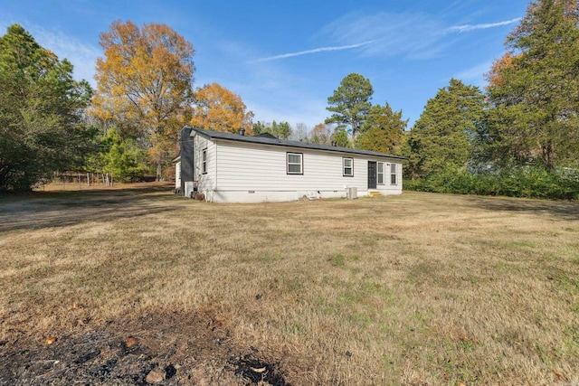 rear view of property featuring a lawn