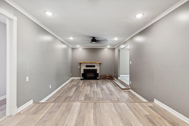 unfurnished living room featuring light hardwood / wood-style floors, a brick fireplace, ceiling fan, and ornamental molding