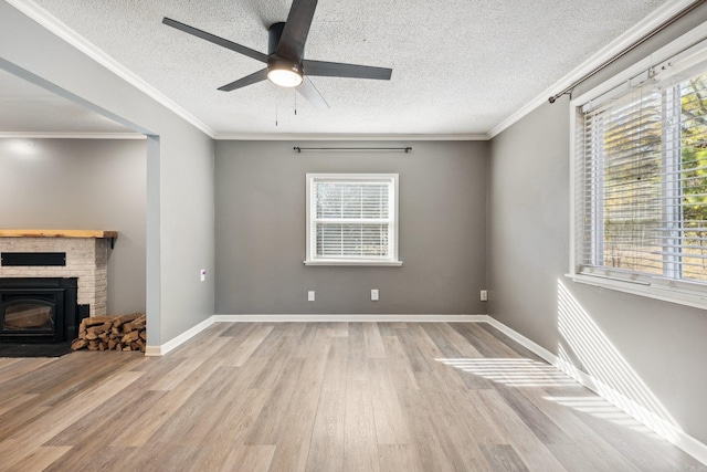 unfurnished living room featuring crown molding, a healthy amount of sunlight, and light hardwood / wood-style floors