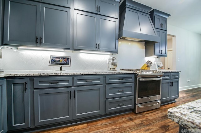 kitchen featuring light stone countertops, dark hardwood / wood-style flooring, stainless steel electric range oven, and premium range hood