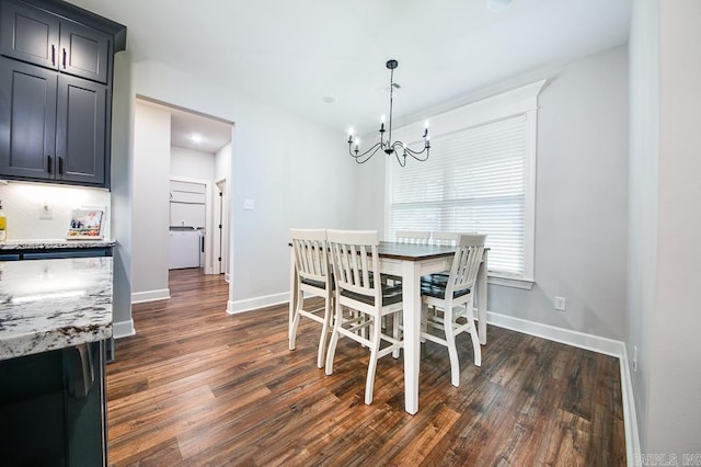 dining area with an inviting chandelier and dark wood-type flooring