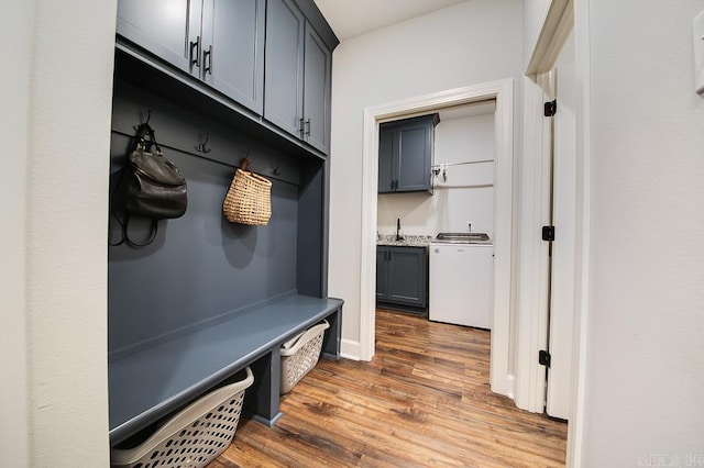 mudroom with dark wood-type flooring and sink