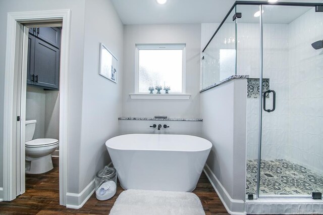 bathroom with separate shower and tub, wood-type flooring, and toilet