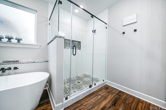 bathroom featuring hardwood / wood-style floors and shower with separate bathtub