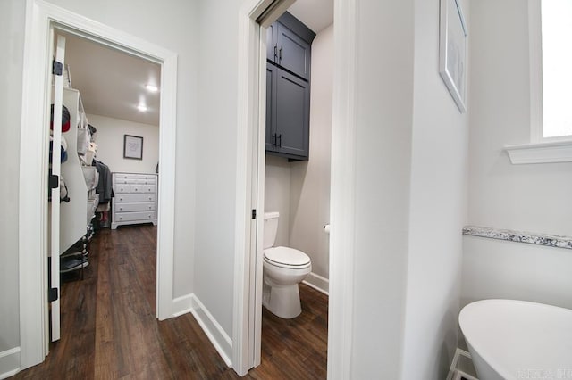 bathroom featuring wood-type flooring and toilet