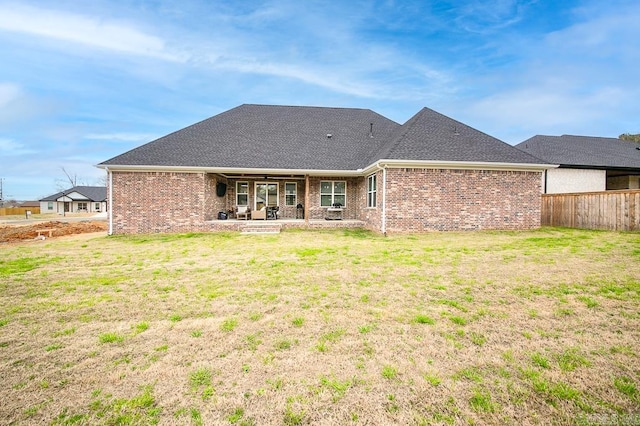 back of property featuring a lawn