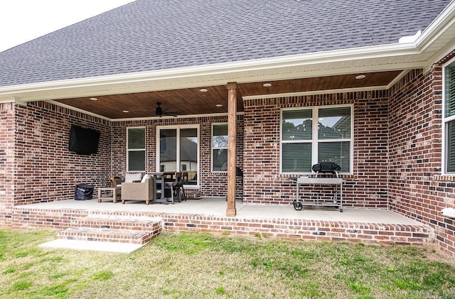 rear view of property featuring a patio area and ceiling fan