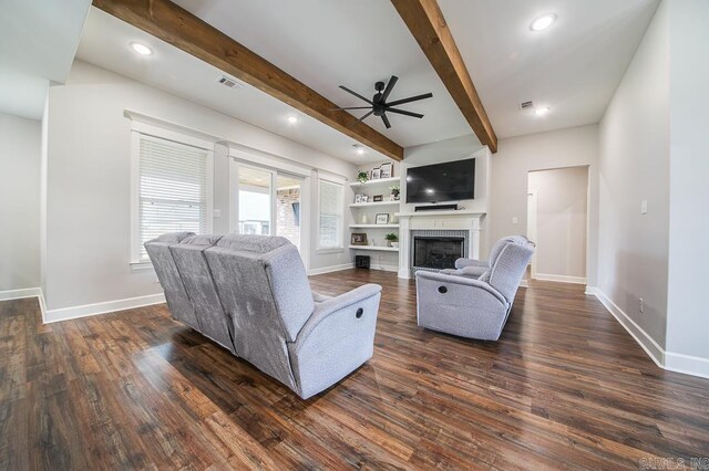 living room featuring beam ceiling, ceiling fan, and dark wood-type flooring