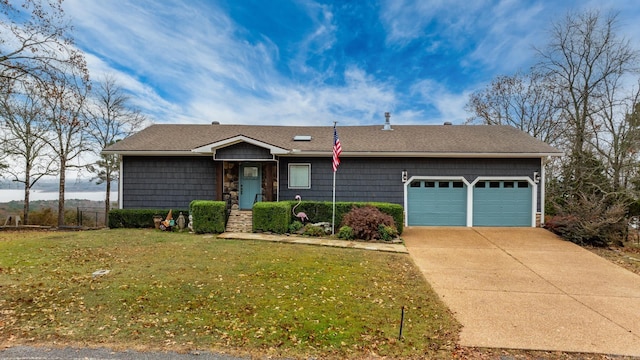 ranch-style house featuring a front yard and a garage