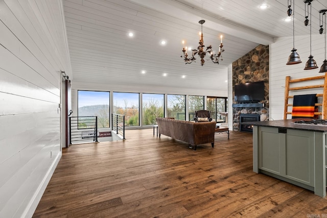 living room featuring high vaulted ceiling, dark hardwood / wood-style floors, a stone fireplace, and a wealth of natural light