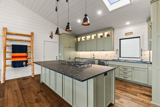 kitchen with a skylight, decorative light fixtures, green cabinetry, a center island, and dark hardwood / wood-style floors