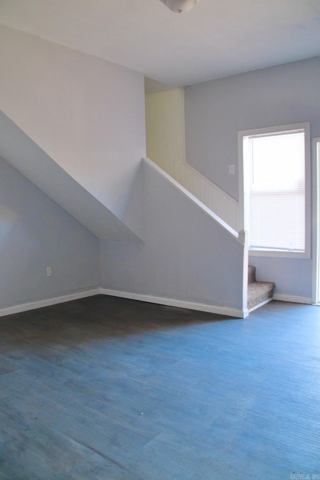 additional living space featuring dark hardwood / wood-style flooring